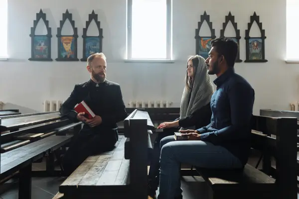a minister talking to a couple inside the church from Concordia Lutheran Church houston in Houston, TX - Children Ministry