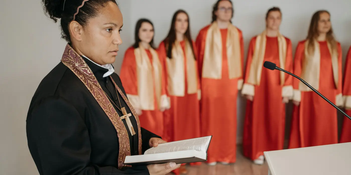 a female minister holding a bible from Concordia Lutheran Church houston in Houston, TX - Youth Ministry