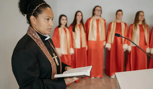 a female minister holding a bible from Concordia Lutheran Church houston in Houston, TX - Youth Ministry